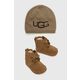 UGG komplet za otroke Baby - rjava. Komplet copati in klobuk iz kolekcije UGG. Model izdelan iz kombinacije tkanine in naravnega usnja.